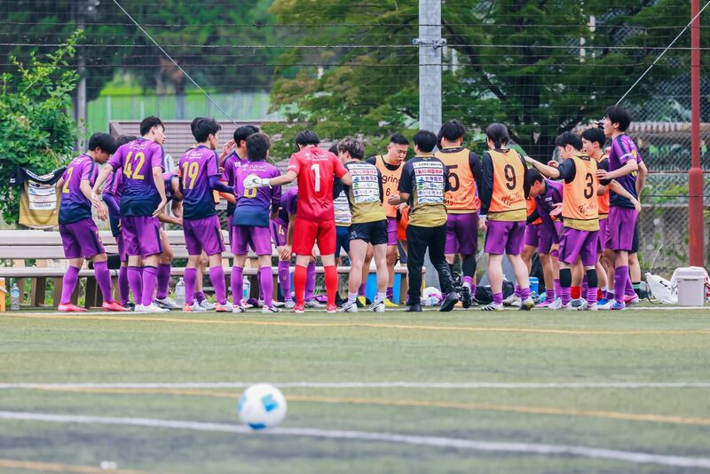 試合会場のベンチ前で円陣を組むF.Cバイオレッツの選手たち。